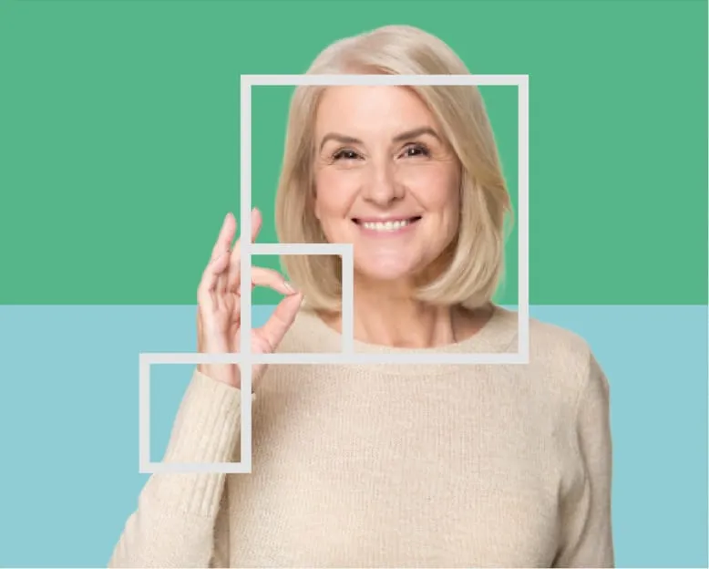 Smiling older woman against green and teal panels
